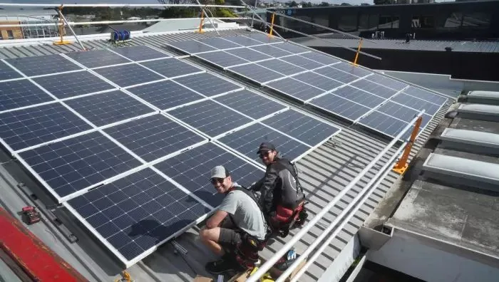 Solar One installers fitting panels on a rooftop